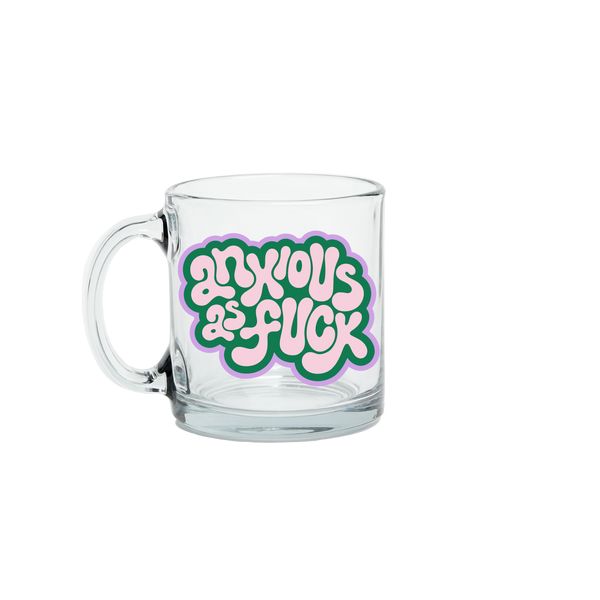 Clear glass mug with colorful text design on a white background