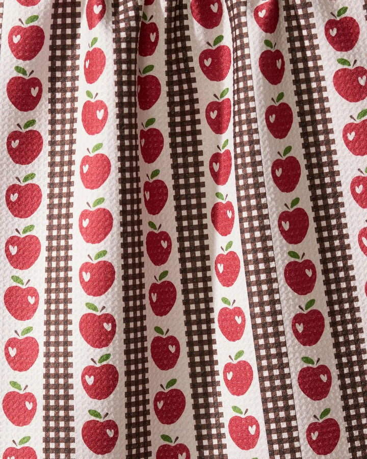Fabric with red apple pattern on a brown and white striped background