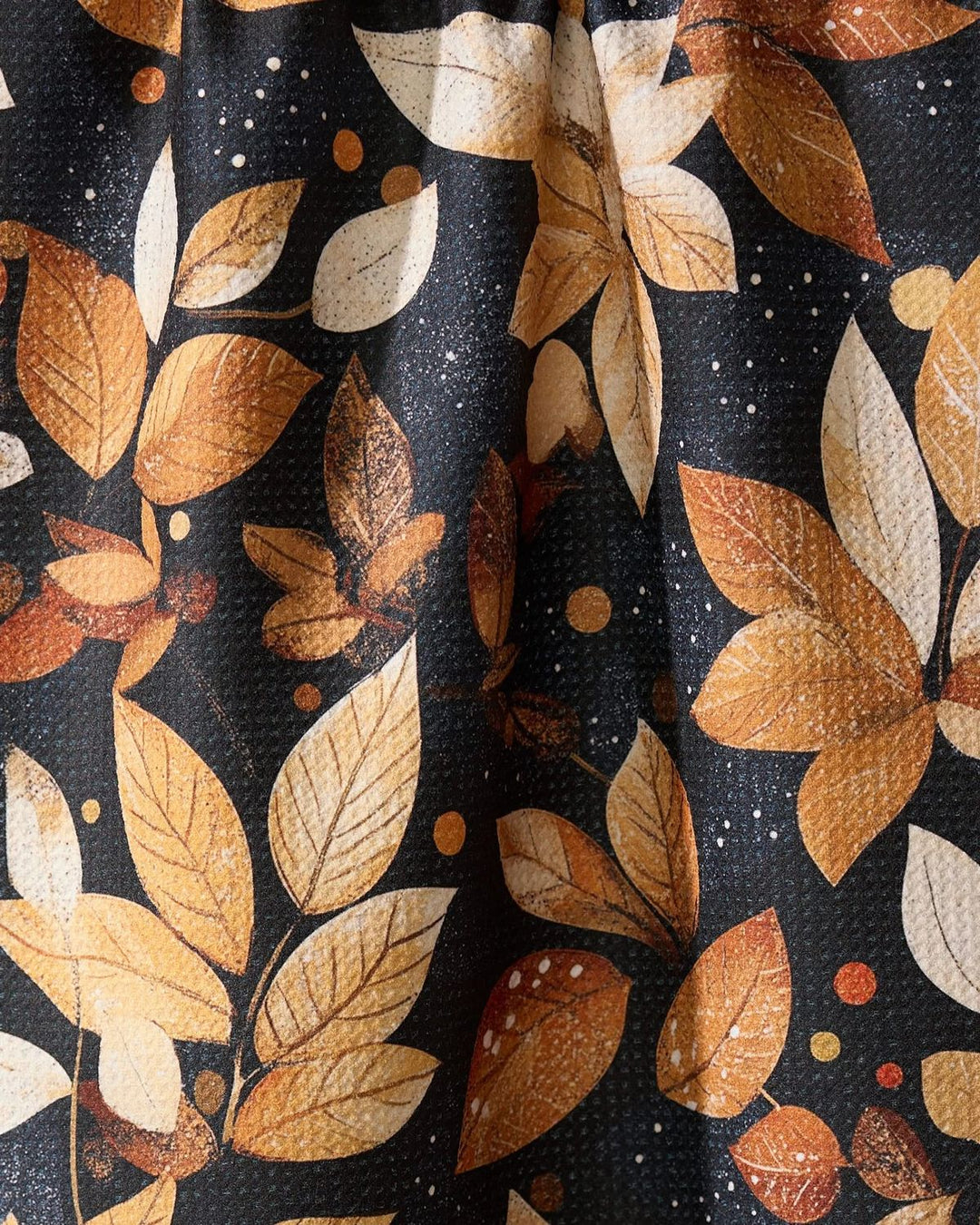 Fabric with autumn leaf pattern on a dark background