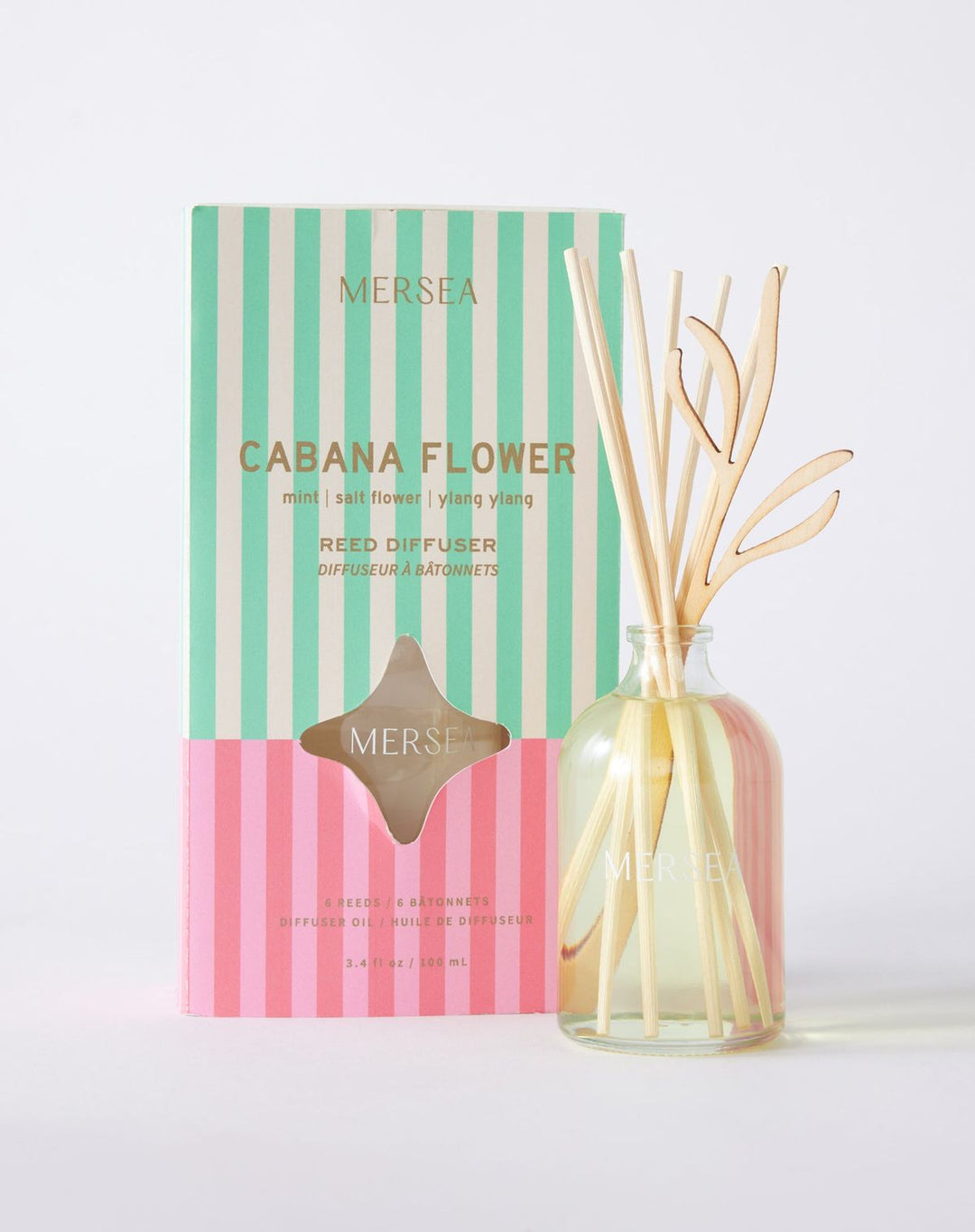 Striped Mersea Cabana Flower diffuser packaging with a glass bottle containing sticks on a light background