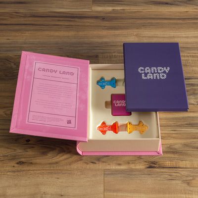 Candy Land game pieces in a box on a wooden surface