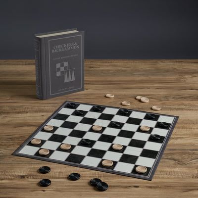 Checkers board with pieces on a wooden surface next to a book titled 'Checkers & Backgammon'.