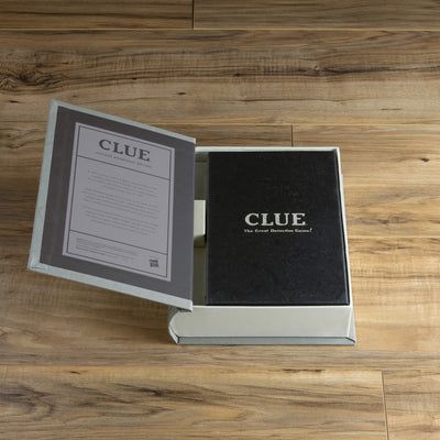 Open box of 'CLUE' game on a wooden surface