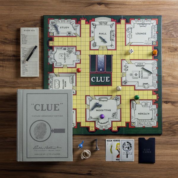 Clue board game with components on a wooden surface