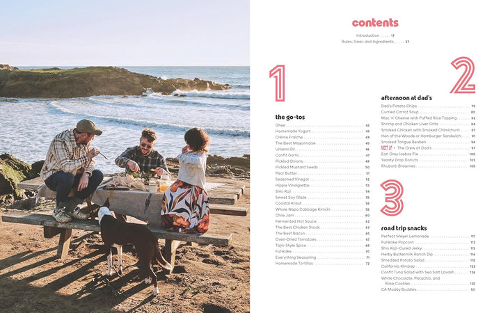 People sitting at a picnic table by the ocean with a magazine layout on the right showing chapter titles.