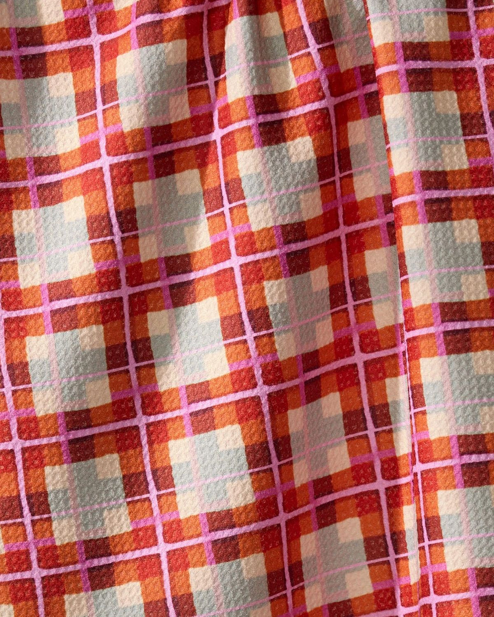 Close-up of a checkered fabric with red, orange, and blue pattern