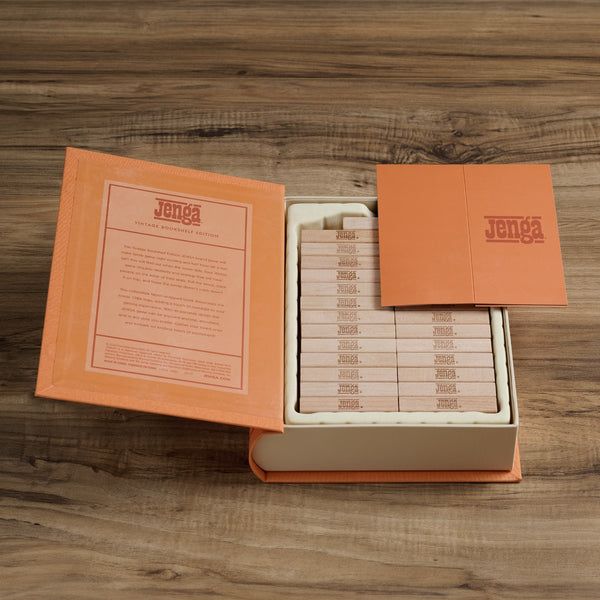 Jenga game set with packaging on a wooden surface