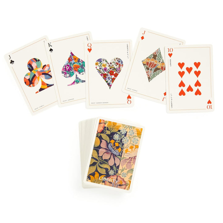 Colorful playing cards with floral designs on a white background