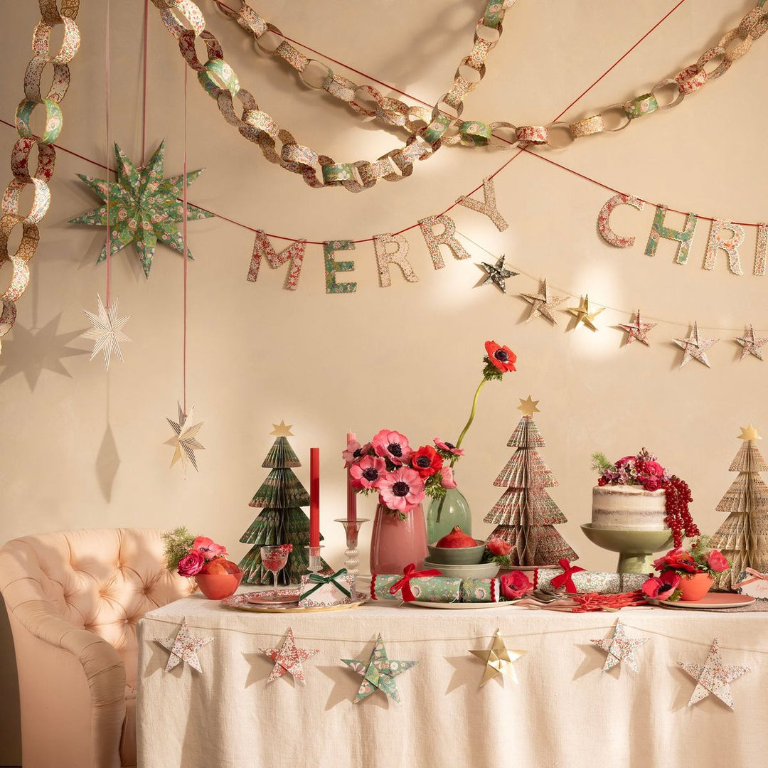 Decorated Christmas table with festive decorations and a 'Merry Christmas' banner.