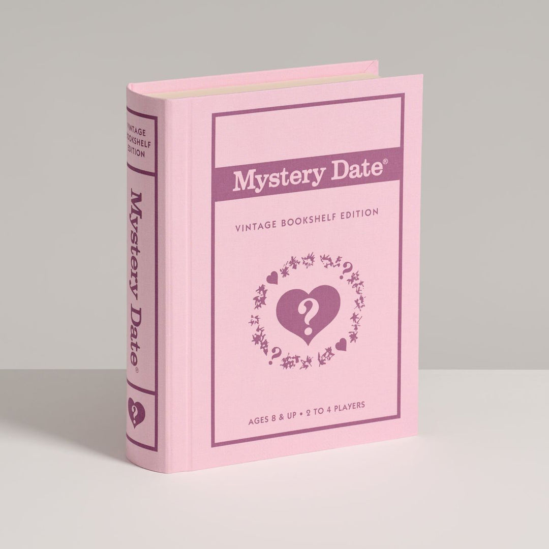 Pink book titled 'Mystery Date' on a gray background