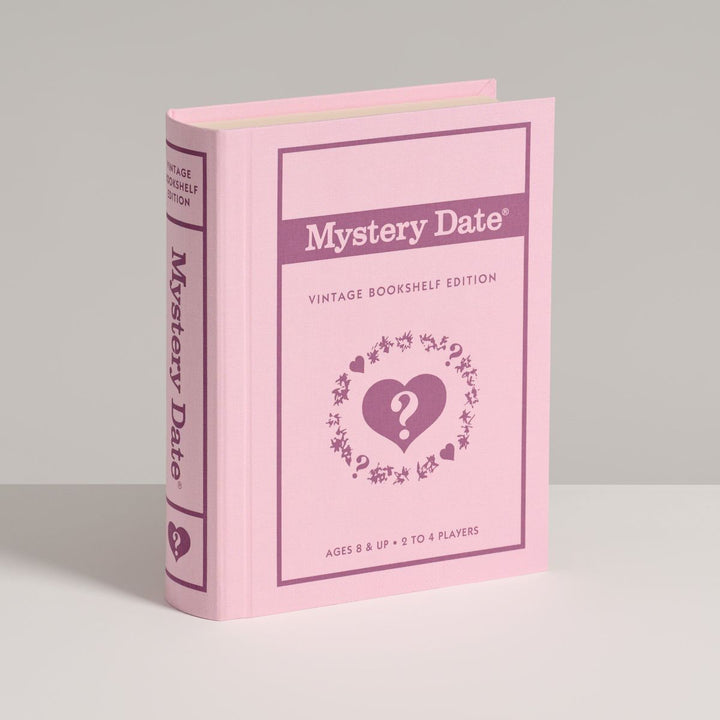 Pink book titled 'Mystery Date' on a gray background