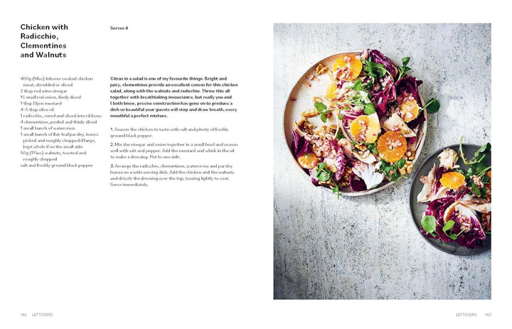 Salad with chicken, radicchio, clementines, and walnuts on a textured surface.