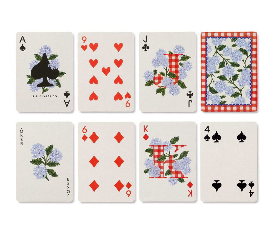 Set of playing cards with floral and checkered designs on a white background