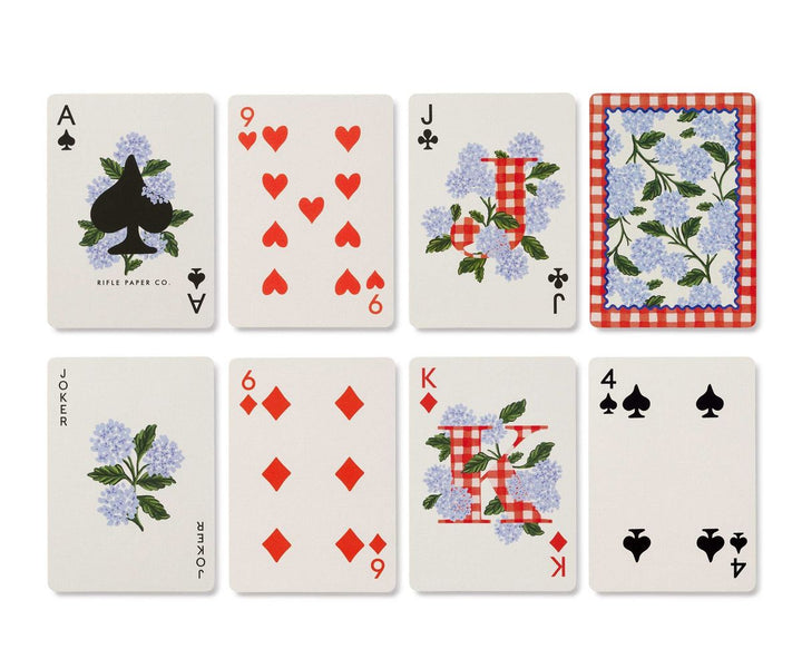 Set of playing cards with floral and checkered designs on a white background