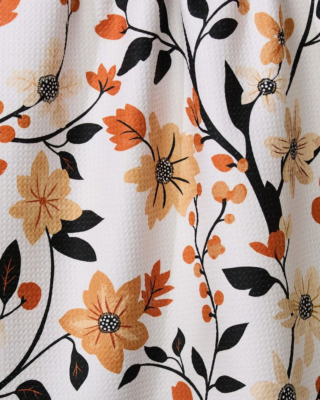 Floral pattern with orange, black, and beige flowers on a white background