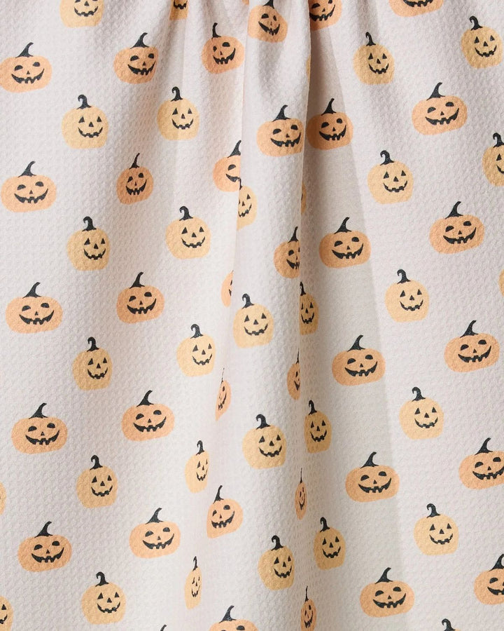 Fabric with Halloween-themed pumpkin pattern on a beige background