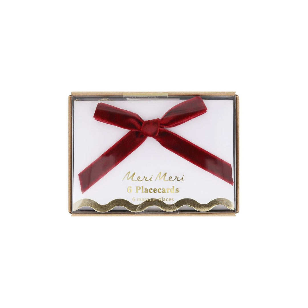 Packaged Meri Meri placecards with a red bow on a white background