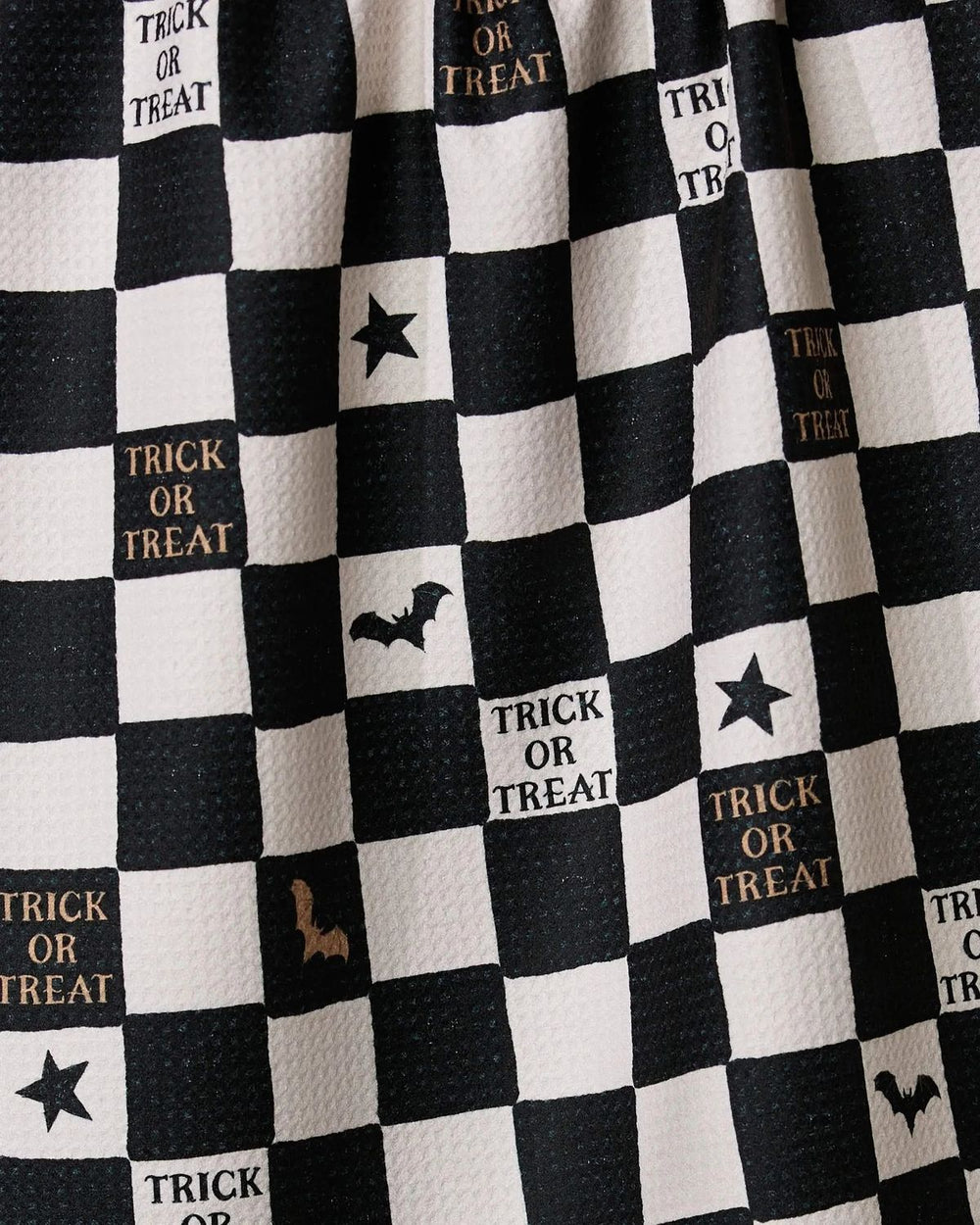 Black and white checkered fabric with Halloween-themed text and symbols.