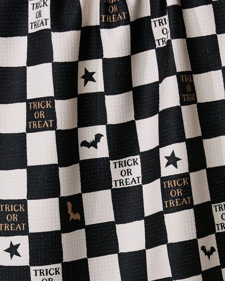 Black and white checkered fabric with Halloween-themed text and symbols.