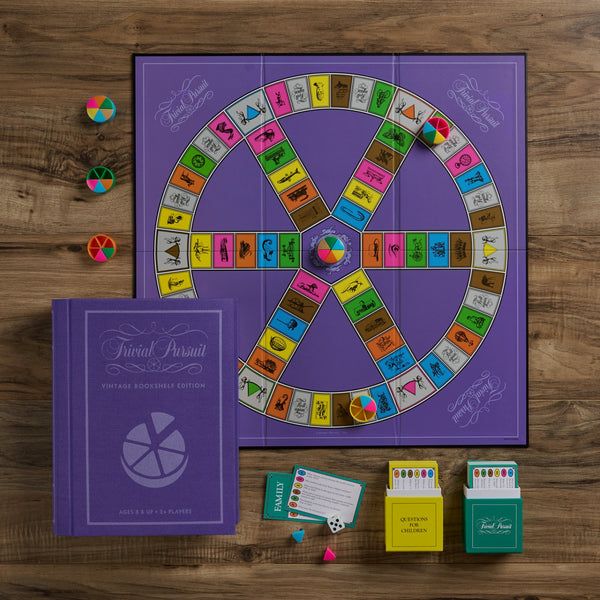 Board game set with colorful pieces and cards on a wooden surface