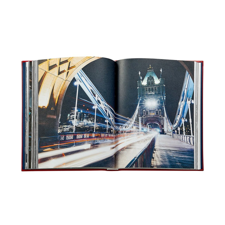 Open book showing a photograph of a bridge at night with lights.