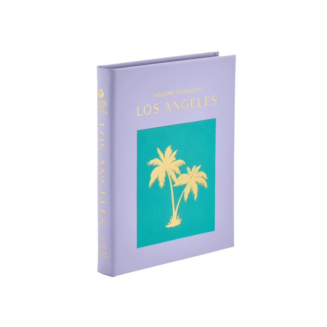 Book with purple cover and teal section featuring palm trees on a white background