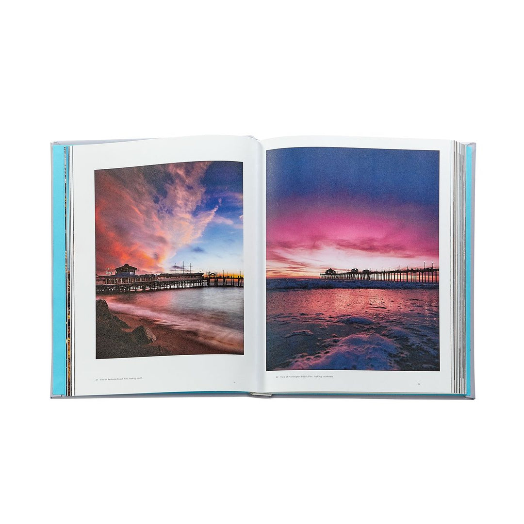 Open book showing a colorful sunset over a pier on two pages.