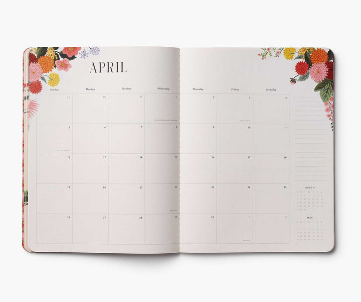 Open planner showing April with floral design on the cover and edges.