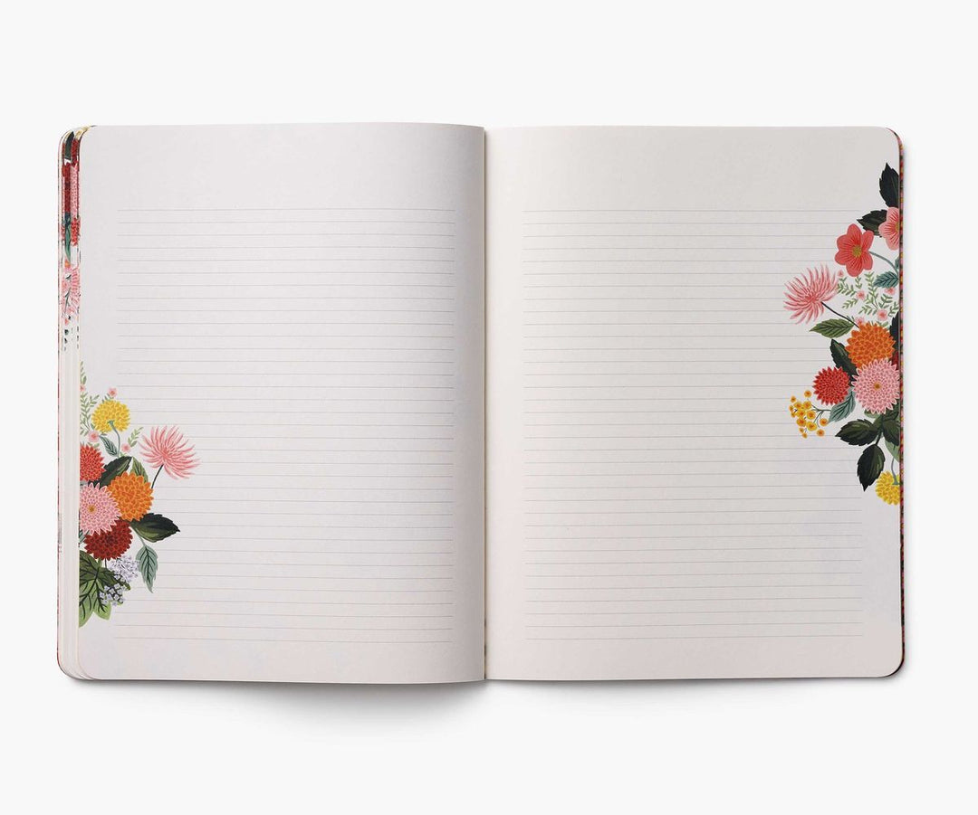 Open notebook with floral designs on a white background