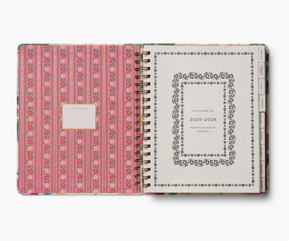Planner with pink patterned cover and white back cover on a white background