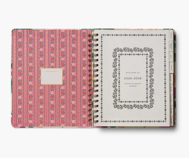 Planner with pink patterned cover and white back cover on a white background