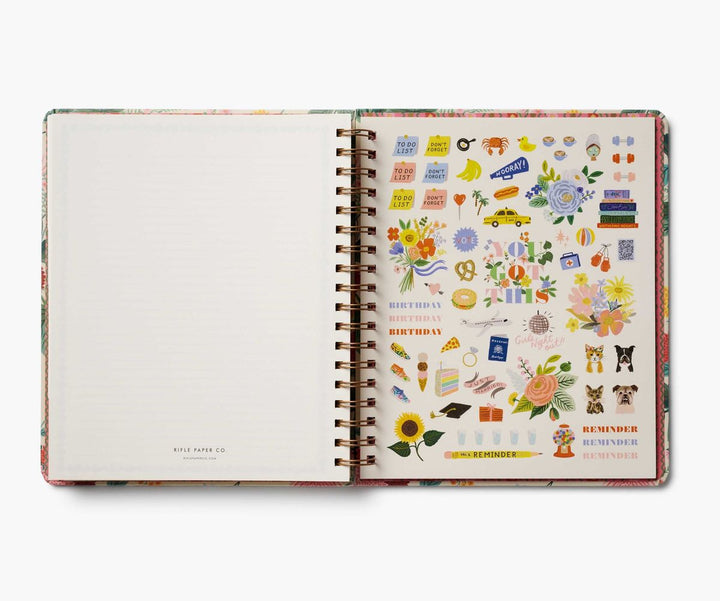 Open planner with colorful stickers on a white background