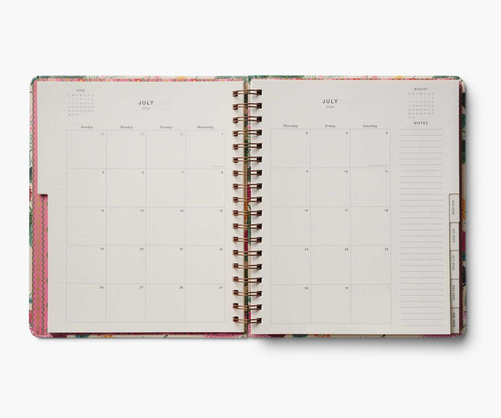 Open planner with monthly calendar and notes section on a white background