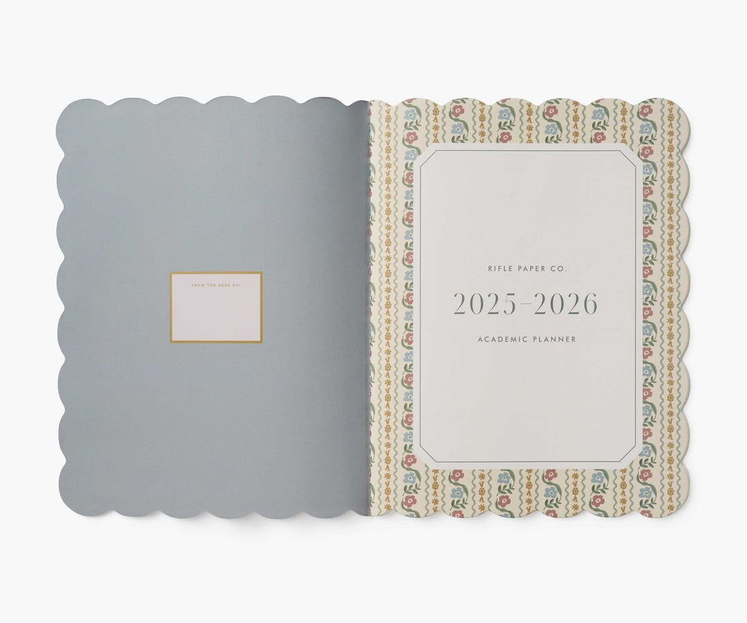 Planner with decorative cover and visible brand name on a white background