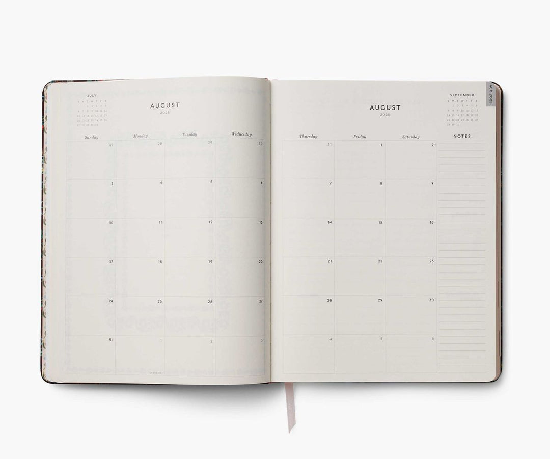 Open planner showing a two-page spread for August on a white background