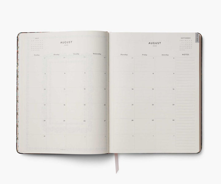 Open planner showing a two-page spread for August on a white background