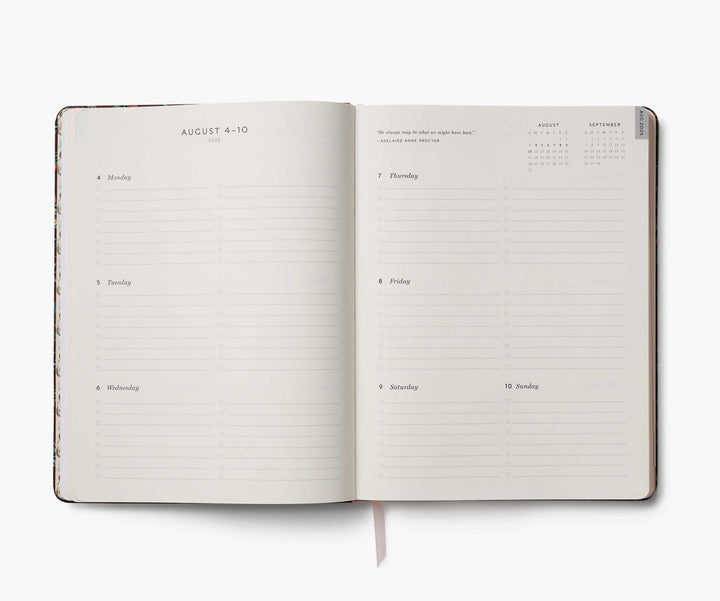 Open planner with daily schedule and notes on a white background