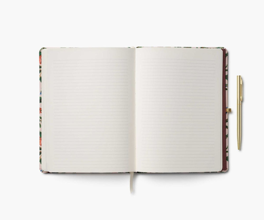 Open notebook with lined pages and a pen on a white background
