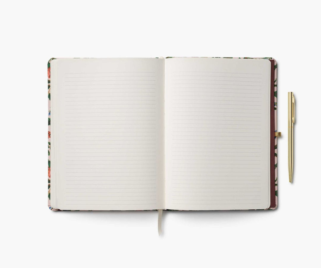 Open notebook with lined pages and a pen on a white background