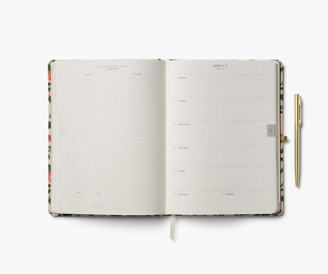 Open planner with floral design on a white background