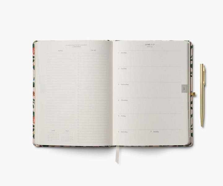 Open planner with floral design on a white background