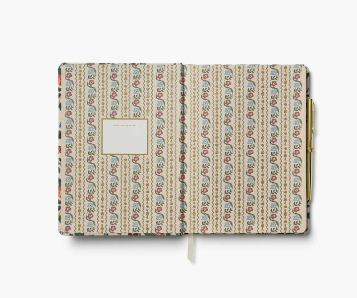 Patterned notebook with a gold clip on a white background