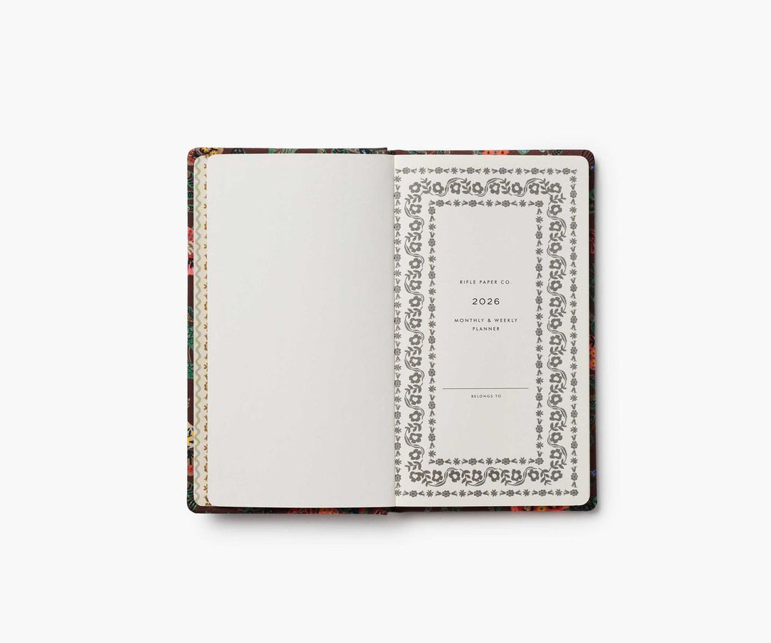 Floral-patterned planner with white cover on a white background