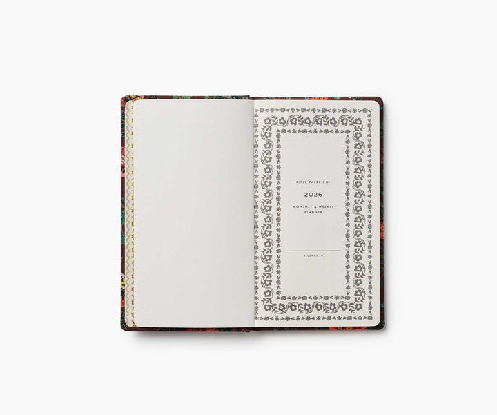 Floral-patterned planner with white cover on a white background