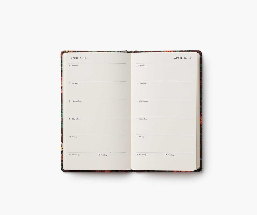 Open planner with floral design on a white background