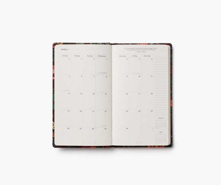 Open planner with floral design on a white background