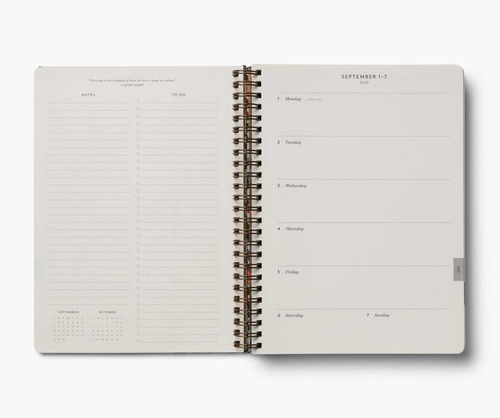 Open planner with daily schedule and calendar on a white background