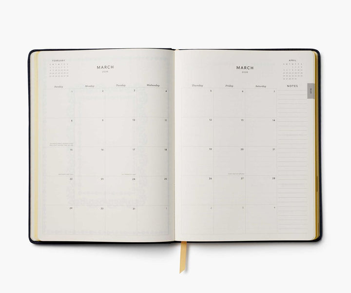 Open planner showing a monthly calendar layout on a white background
