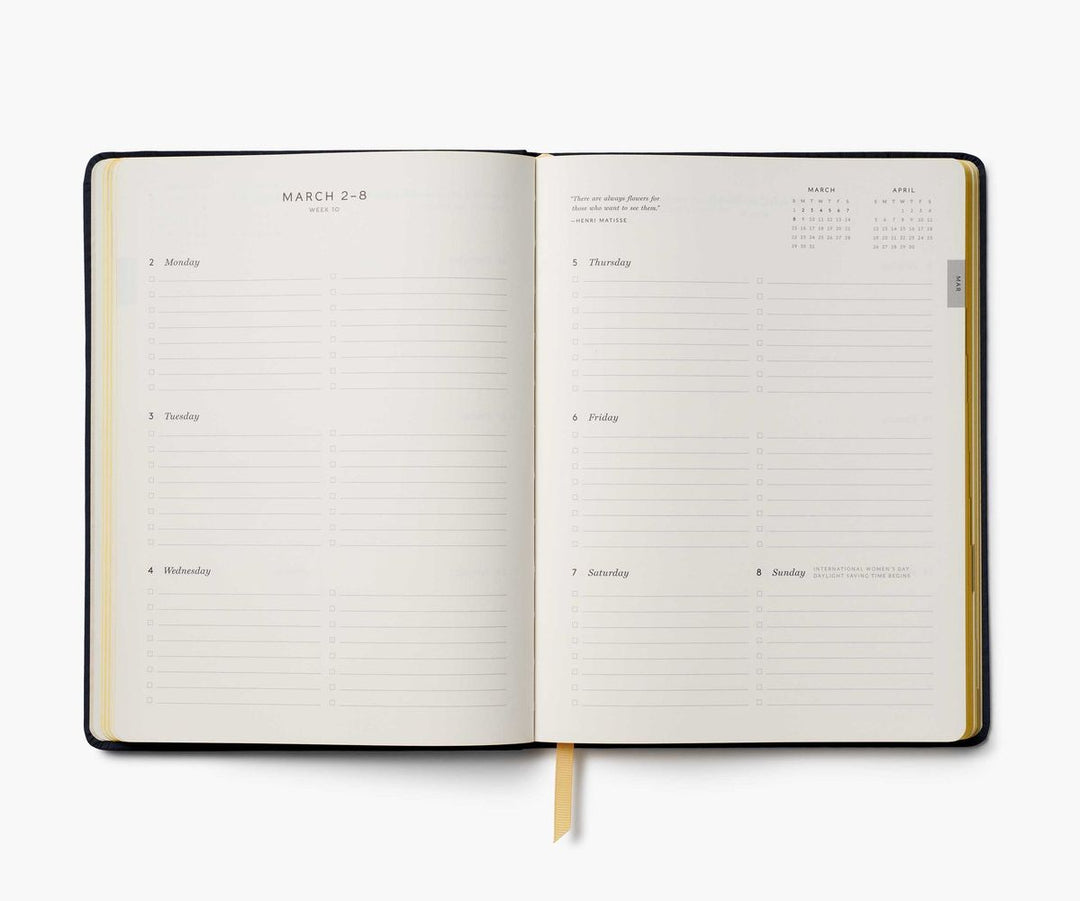 Open planner with daily schedule on a white background