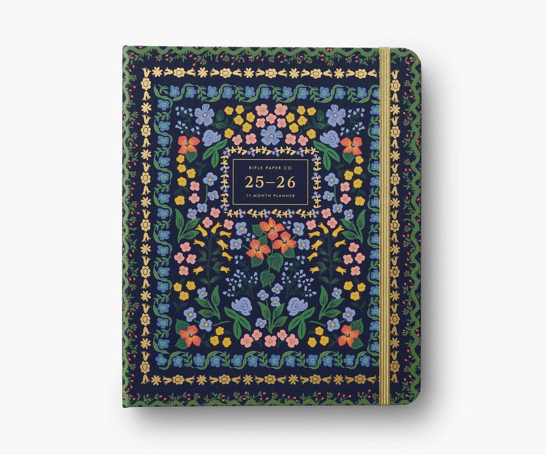 Floral patterned planner with a gold spine on a white background
